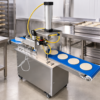 Automatic Pancake Forming Machine in a commercial processing environment Automatic Pancake Forming Machine in a commercial processing environment